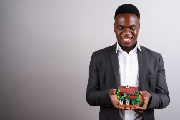 picture of a nigerian diaspora man holding a property shown by ATLAS Realtors