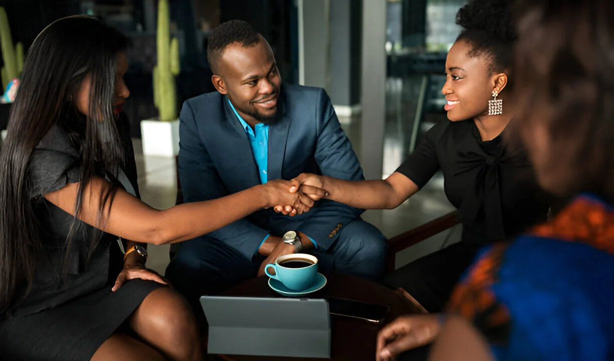 Hands shaking over property documents symbolizing trust in Lagos real estate due diligence.